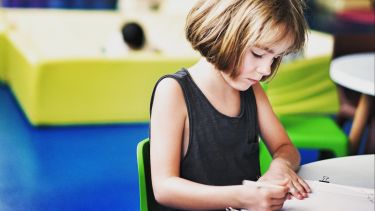 Photograph of young girl drawing