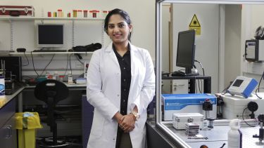 A bioengineering student wearing a lab coat