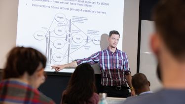 An academic in the School of Health and Related Research delivering a lecture.