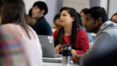 A group of students listen intently to a School of Health and Related Research lecture. 