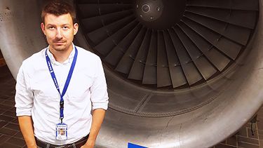 A photo of Lucas next to a plane jet.