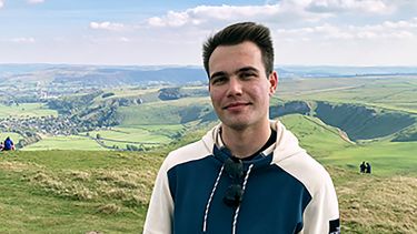 A headshot of Marton outside.