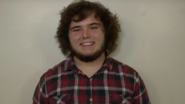 A profile picture of Russell Grim. He has on a tartan shirt.