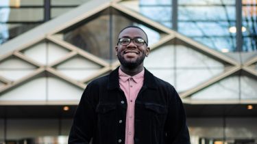 A placement student stands outside the Diamond building