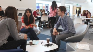 Management students discussing at table