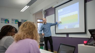 Lecturer giving a presentation to students