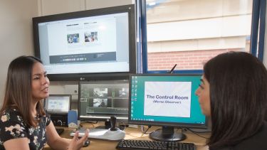 Two students using facilities in the Information School.