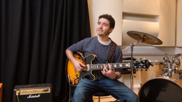 Student playing guitar