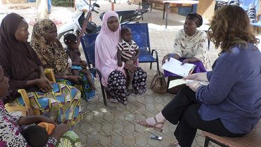 Emma speaking with a group of local people in Niger. 