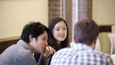 Students talk in seminar room