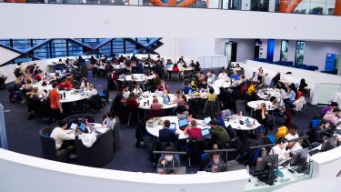 A wide shot of students sat at tables in The Diamond.