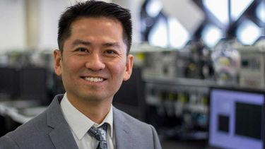 A photo of Professor Chee Tan in a computer lab - image