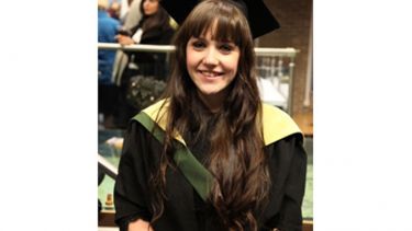 Emily Ball in cap and gown at graduation