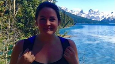 A profile photo of Emma Blakey stood in front of a lake