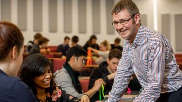 Gary Wood assisting students in a lecture