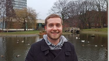 Jake Toth stood in Weston Park by a pond