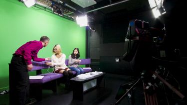 Students in the Journalism Studies TV studio preparing to present a broadcast