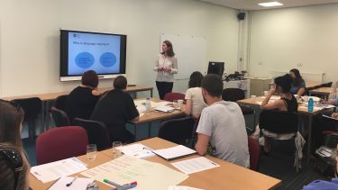 Lecturer presenting a slideshow to a classroom of students