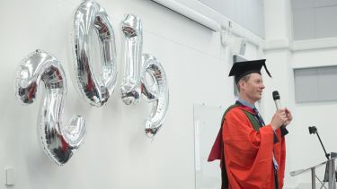 Man gives a speech to graduates