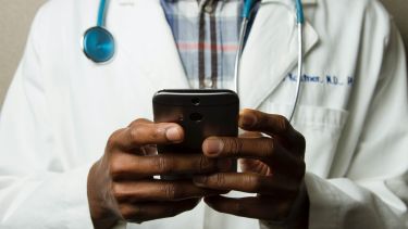 Doctorl with mobile phone
