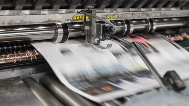 Newspaper rolling off a prinitng press