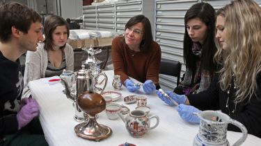 History students discussing different artefacts in a seminar.