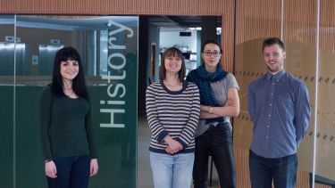 A group of History students standing in front of the History department.