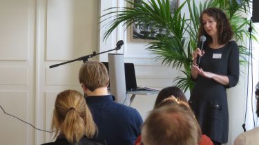 Dr Caroline Oates delivering an invited presentation in Brussels