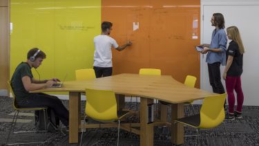 An image showing students collaborating on Level 4 of the Information Commons.