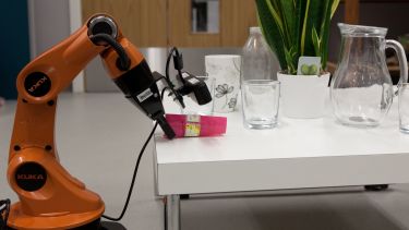 A picture of the Kuka arm grasping an object