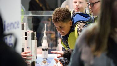 Child interacting with a toy rocket as part of the Aerospace engineering box