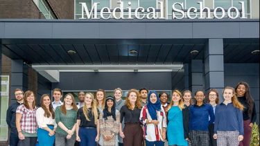 Postgraduate students stood in front of the Medical School