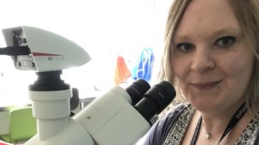 Yvette Marks with a microscope