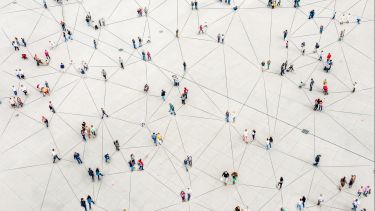 Bird's eye image of people stood apart from one another with a series of lines on the ground connecting them together