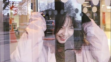 Xiangyi Li putting her hood up, smiling