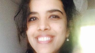 Anjana smiling, in front of a window