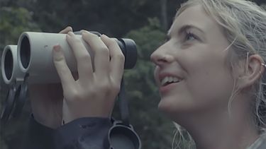 Natasha Ellison holding some binoculars