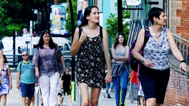 Students and parents walking through campus on a University open day. 