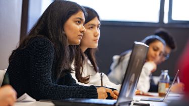 Female students listening to lecture