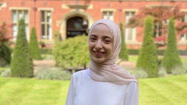 Profile photo of MSc student in front of a red brick building