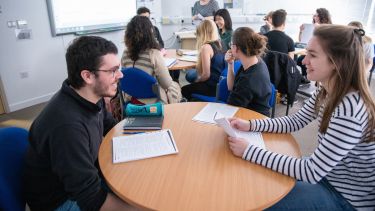 Two students discuss a task