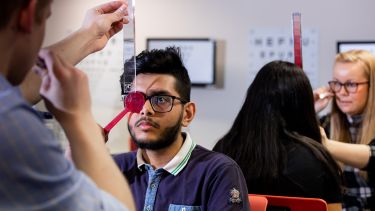 Students testing eye sight of other students