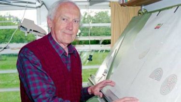 Vic King stood at his drawing board. Photo by Neil Watson