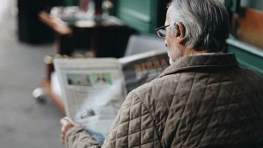Elderly man reading a newspaper