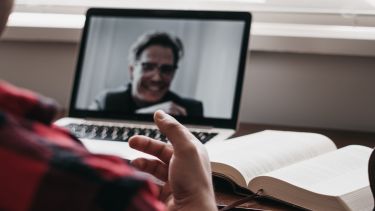 Person talking to another person on screen