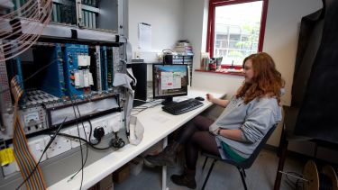 A student in a particle physics laboratory