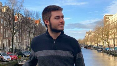 Student Rober Heaney on a bridge in Amsterdam