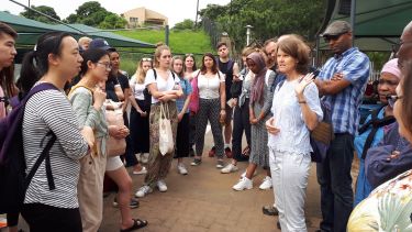 Students listen to tour guide in Durban