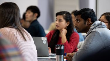 A group of students listen to a lecture