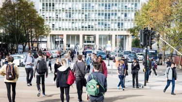 Students crossing the road in front of the Arts Tower